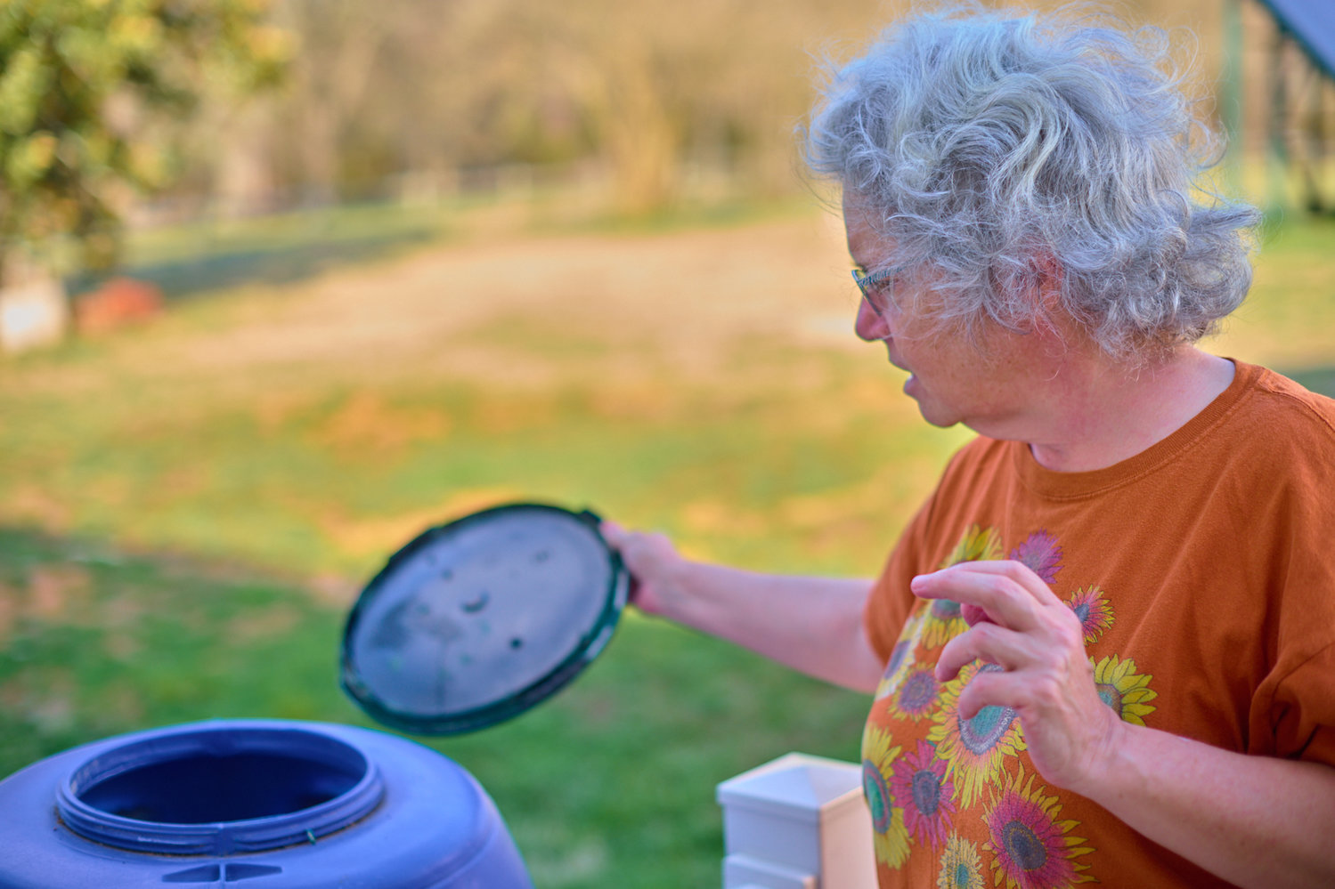 Nancy Van Camp, wife of Dr. John Dykers, shows one of their 55-gallon drums they use to store their urine. The Siler City couple hope to use the bodily fluid as fertilizer for their farm.